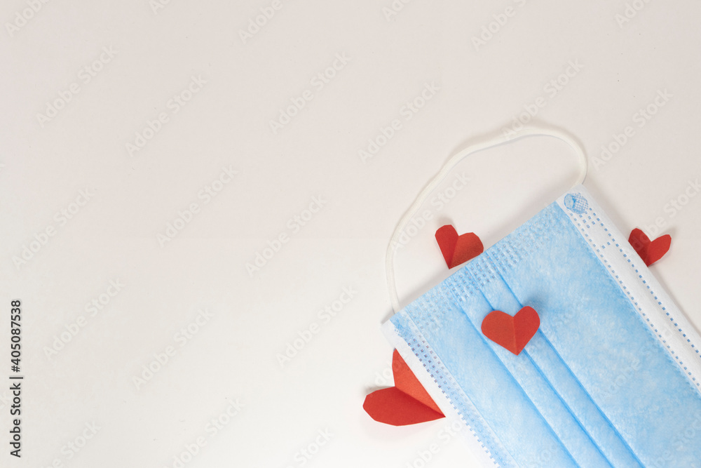 red heart on a mask on valentine's day on a white isolated background. heart surgical mask with place for inscription, mock up, copy space red heart on a mask on valentine's day on a white isolated background. heart surgical mask with place for inscription, mock up, copy space
