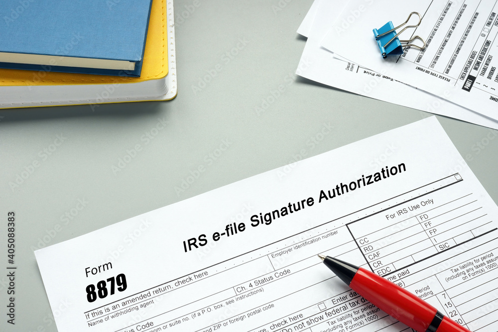 Financial concept meaning Form 8879 IRS e-file Signature Authorization with sign on the page. Financial concept meaning Form 8879 IRS e-file Signature Authorization with sign on the page.
