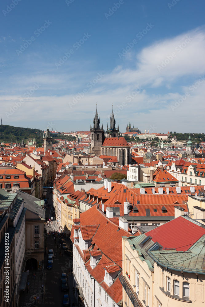 Tynsky and St Vitus cathedral among the red roofs of Prague. View from above