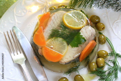 Jellied sturgeon with lemon, olives and glasses of white wine photo