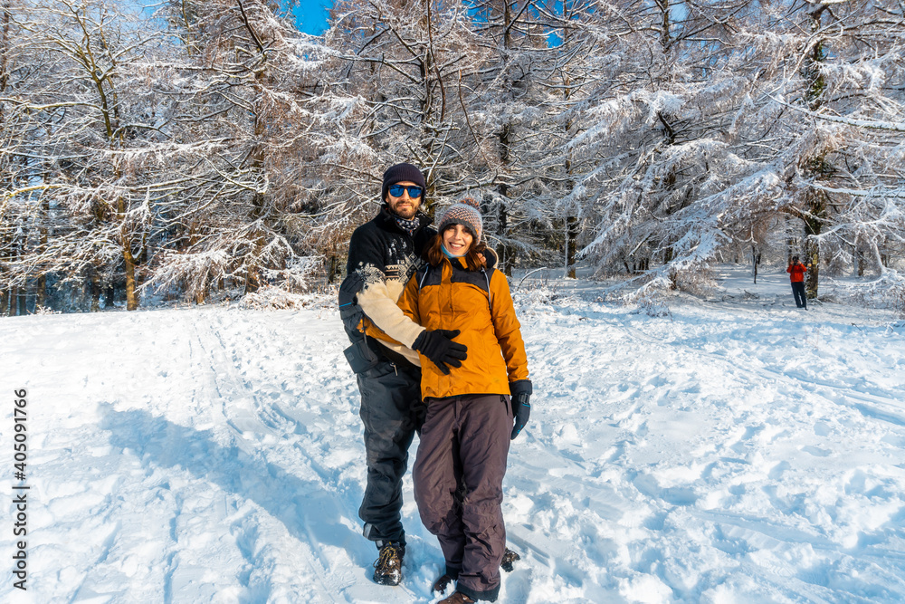 A young couple enjoying in the snowy forest in the month of January in the Artikutza natural park in Oiartzun near San Sebastián, Gipuzkoa, Basque Country. Spain