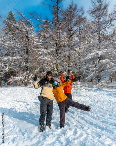 Three friends enjoying in the snowy forest in the month of January the Artikutza natural park in oiartzun near San Sebastián, Gipuzkoa, Basque Country. Spain