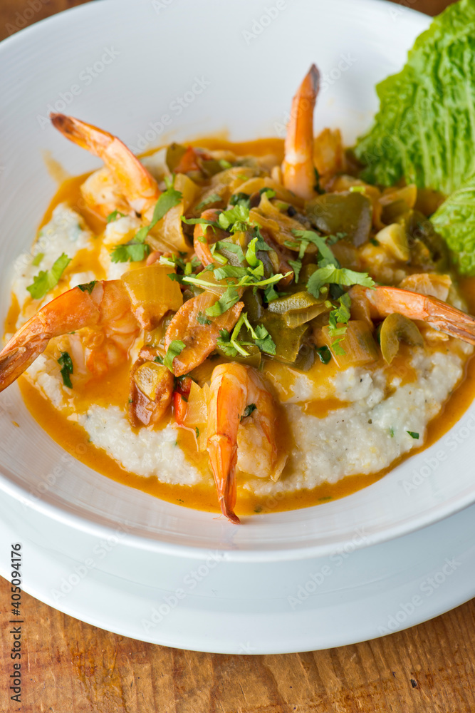 Shrimp and Grits. Grits and old bay seasoned jumbo shrimp topped with spices and micro greens. Classic American Diner Style Breakfast or Brunch menu item. Traditional low country southern staple. Shrimp and Grits. Grits and old bay seasoned jumbo shrimp topped with spices and micro greens. Classic American Diner Style Breakfast or Brunch menu item. Traditional low country southern staple.