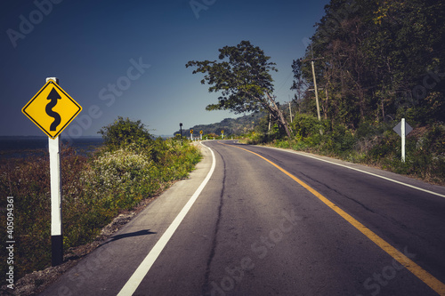  Road with traffic alerts downhill slope. 