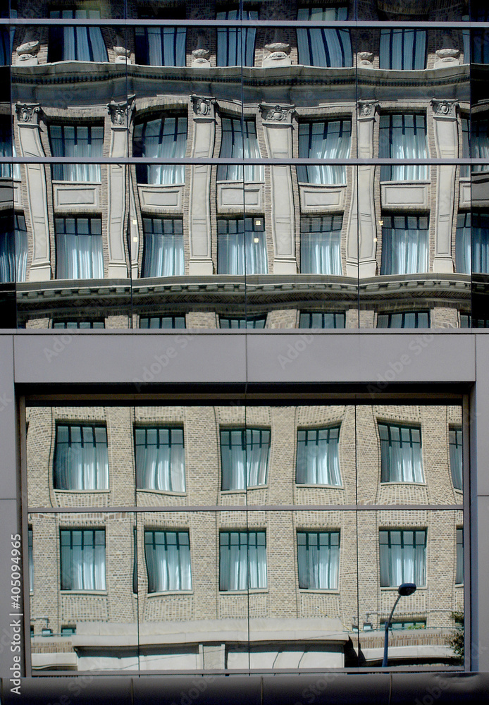 Reflections of architecture on the mirrored glass windows of a building in an American metropolis