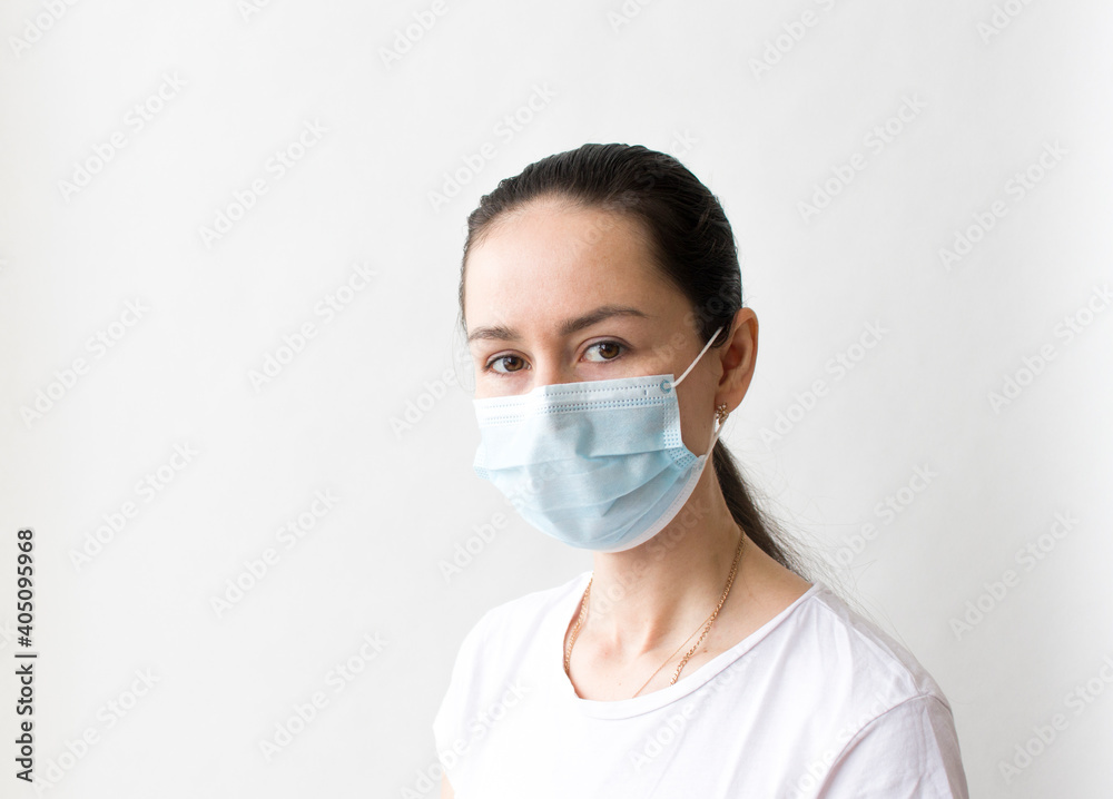 Head and shoulders portrait of female doctor wearing protective mask and looking at camera posing against white background, copy space Head and shoulders portrait of female doctor wearing protective mask and looking at camera posing against white background, copy space
