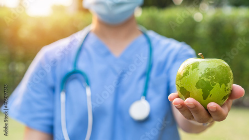 World health day with an apple a day keeps the doctor away concept for health benefit by eating high nutritious food and healthy diet photo