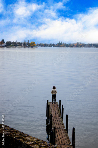Slika na platnu Single lady standing alone on edge of footbridge with  freedom moment and peaceful atmosphere in nature,loneliness concept,Back view
