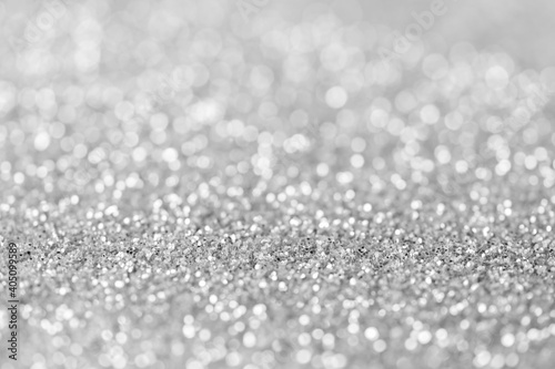 blurred sparkling silver color glitter light as abstract festive background for website banner and card decoration design
