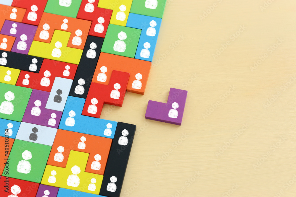 image of tangram puzzle blocks with people icons over wooden table ,human resources and management concept image of tangram puzzle blocks with people icons over wooden table ,human resources and management concept