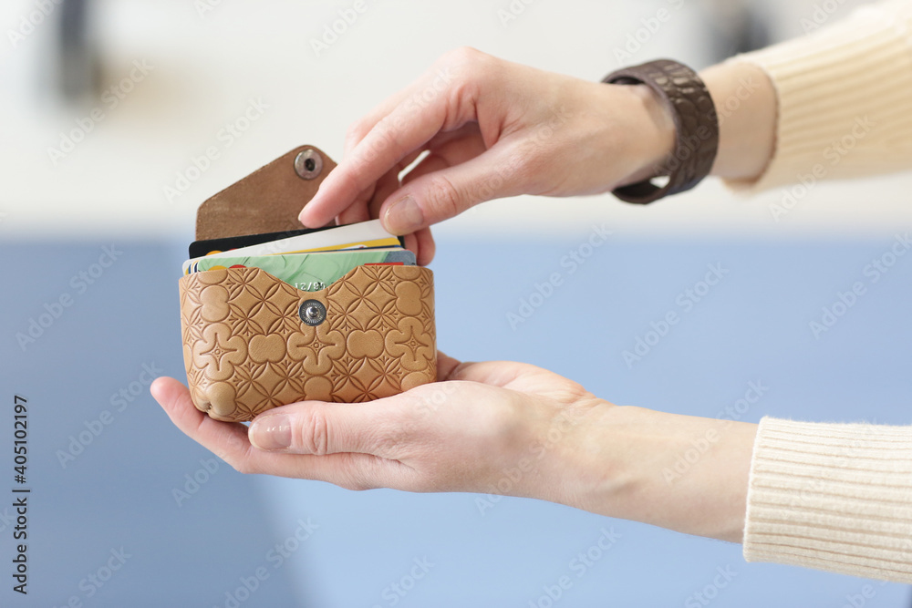 Obraz premium leather business card holder closeup photo in human hands on shopping mall background