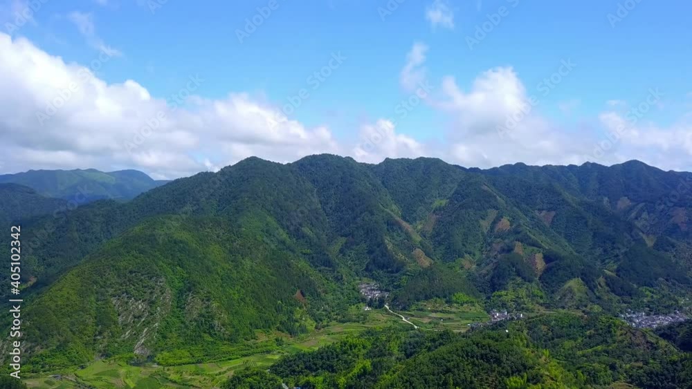 Aerial photography of green mountains and villages, panning shot Aerial photography of green mountains and villages, panning shot
