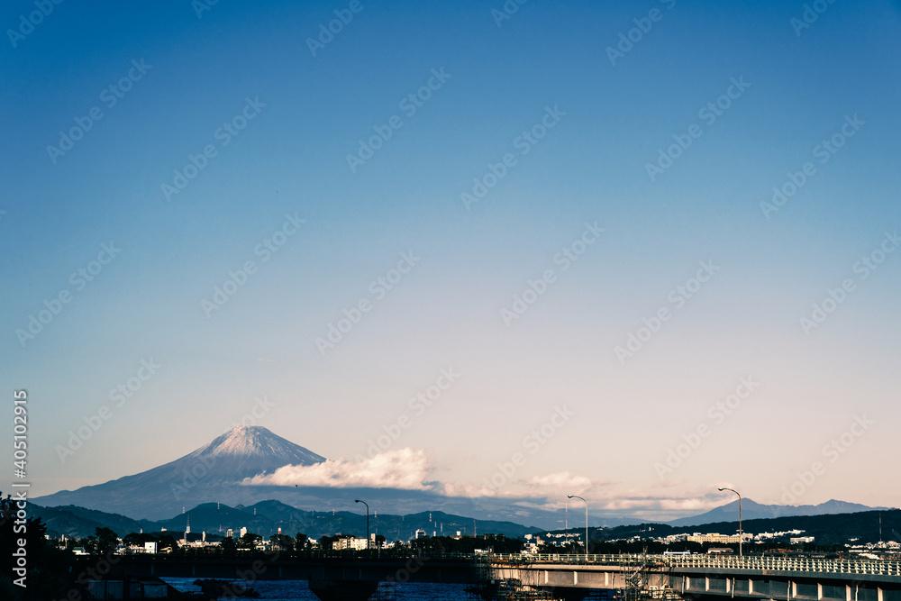 Mt. Fuji seen with warm tone on the left over the road over the Japanese bridge (Horizontal)