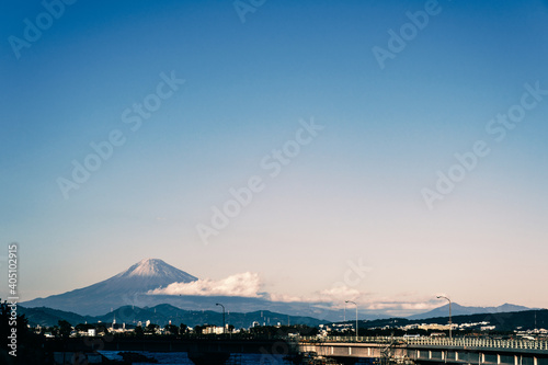 Mt. Fuji seen with warm tone on the left over the road over the Japanese bridge  Horizontal 