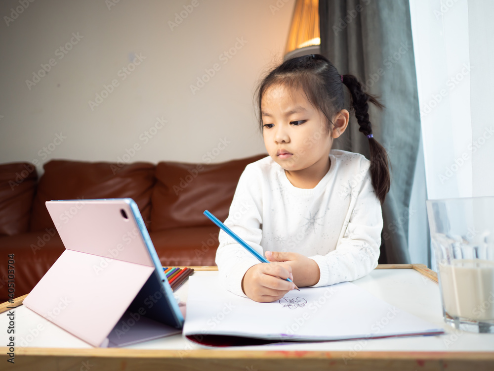 Asian children girl pay attention to online class via tablet Asian children girl pay attention to online class via tablet
