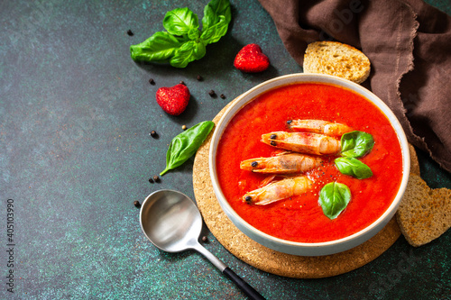 Traditional homemade gazpacho cold soup. Tomato soup puree gazpacho with tomatoes served seafood on a stone background. Copy space.