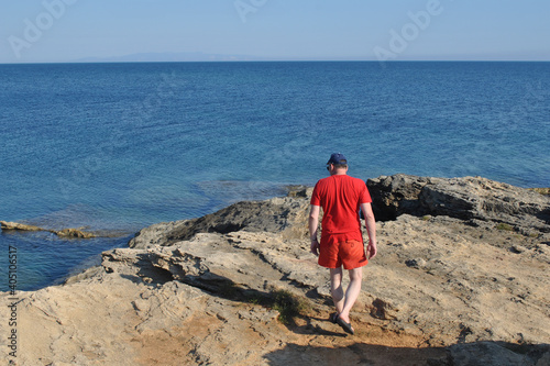 Man walking on the rocky beach