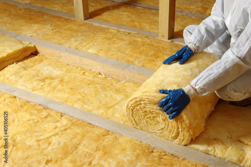 Worker insulate the attic with mineral wool photo