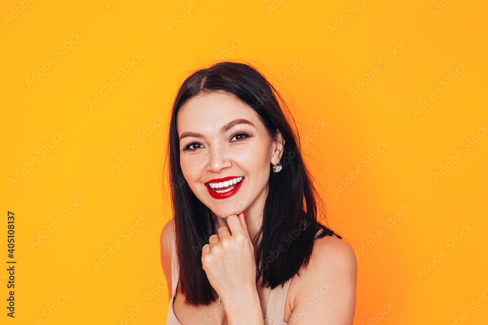 Young woman standing in front of a yellow background. Dental clinic advertisement. Health care. Do-it-yourself makeup at home Young woman standing in front of a yellow background. Dental clinic advertisement. Health care. Do-it-yourself makeup at home