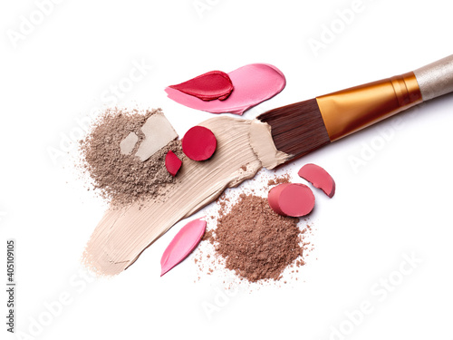 Smears of foundation for face. Pink red lipstick smeared on white background. Loose Eye Shadow. Cosmetic products. Beauty and makeup concept photo