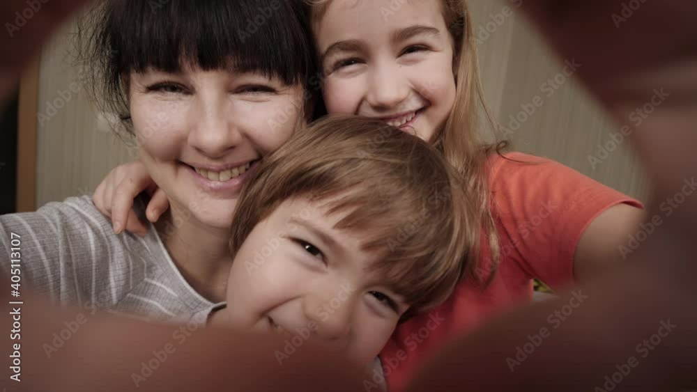 Mother and Kids Making Heart Shape From Hand at Home. Portrait Happy Children With Mother Join Hands Forming Heart Shape of Giving Love, Children Mum Connection, Cute Kids Mom Looking at Camera. Mother and Kids Making Heart Shape From Hand at Home. Portrait Happy Children With Mother Join Hands Forming Heart Shape of Giving Love, Children Mum Connection, Cute Kids Mom Looking at Camera.