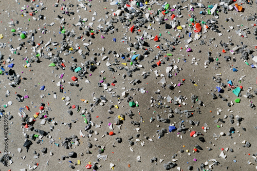 Multicolor glass shards on sand
 photo