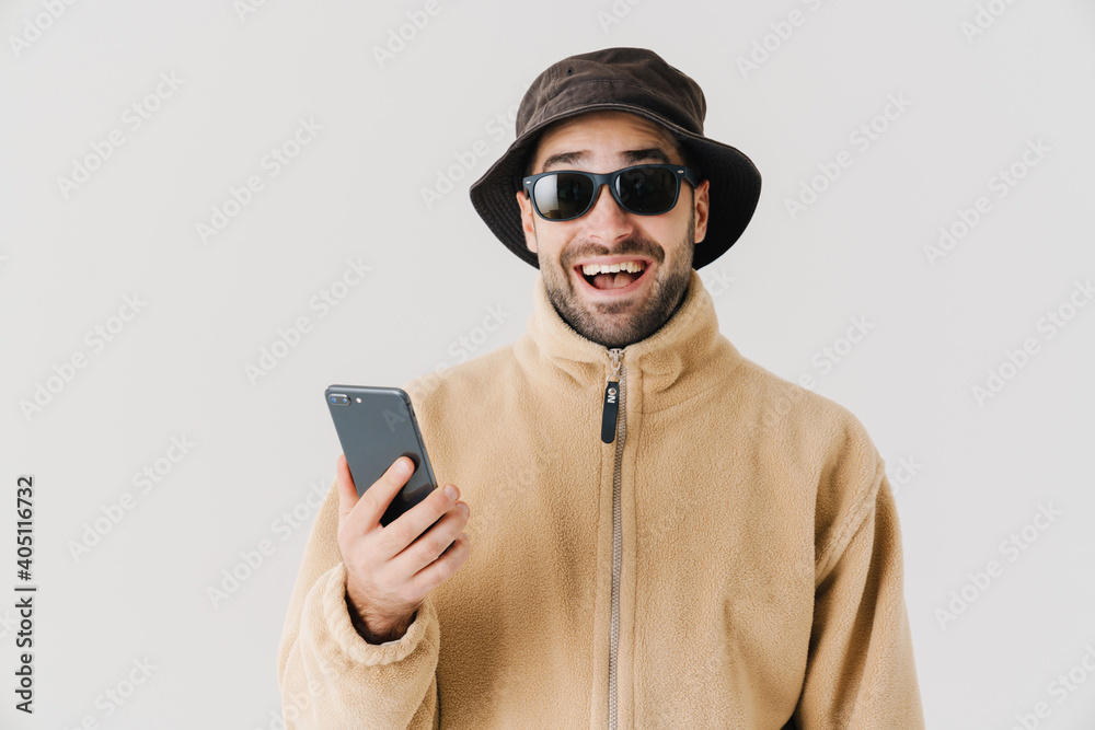 Portrait of a happy young man wearing beige jacket Portrait of a happy young man wearing beige jacket