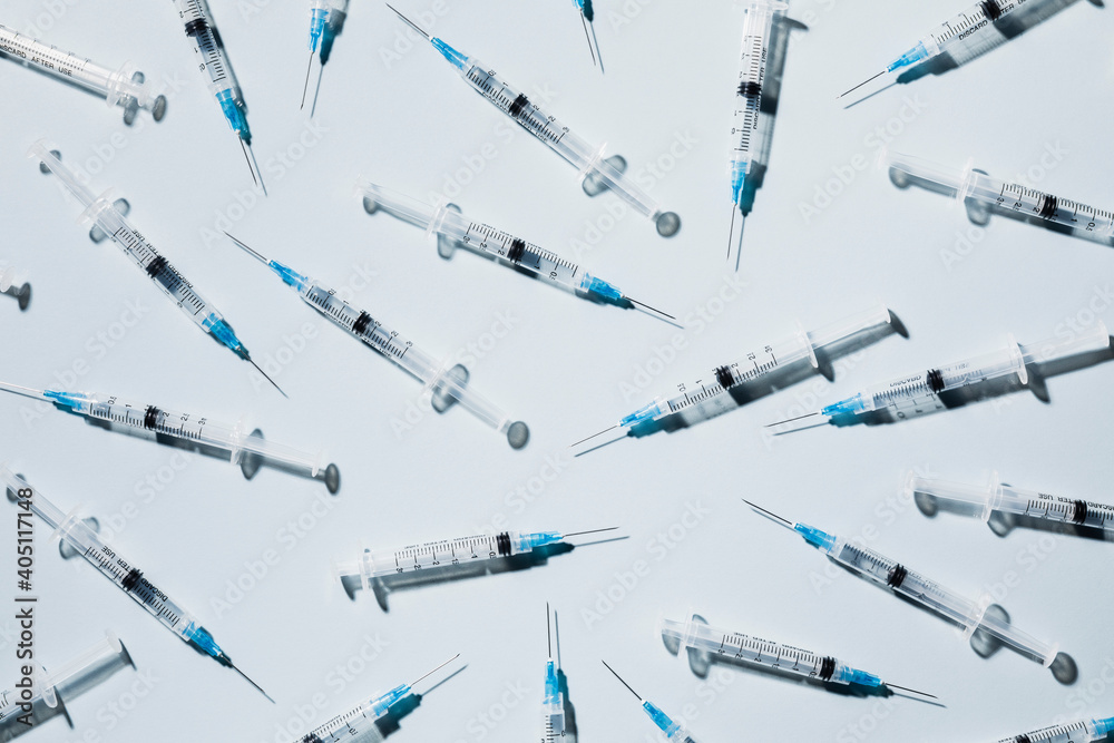 COVID-19 vaccine syringes on blue background
COVID-19 vaccine syringes on blue background