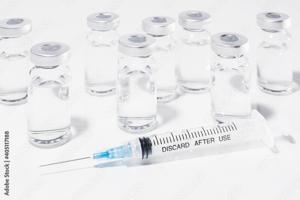 COVID-19 vaccine vials and syringe on white background
COVID-19 vaccine vials and syringe on white background