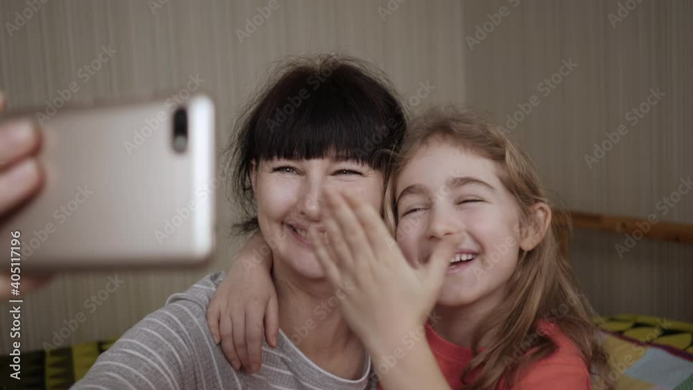 Video Call Family Selfie. Portrait Mother and Kids Kissing on Camera. Happy Mother With Her Kids are Making Selfie or Video Call to Father or Relatives in Bed. Technology, New Generation Parenthood. Video Call Family Selfie. Portrait Mother and Kids Kissing on Camera. Happy Mother With Her Kids are Making Selfie or Video Call to Father or Relatives in Bed. Technology, New Generation Parenthood.