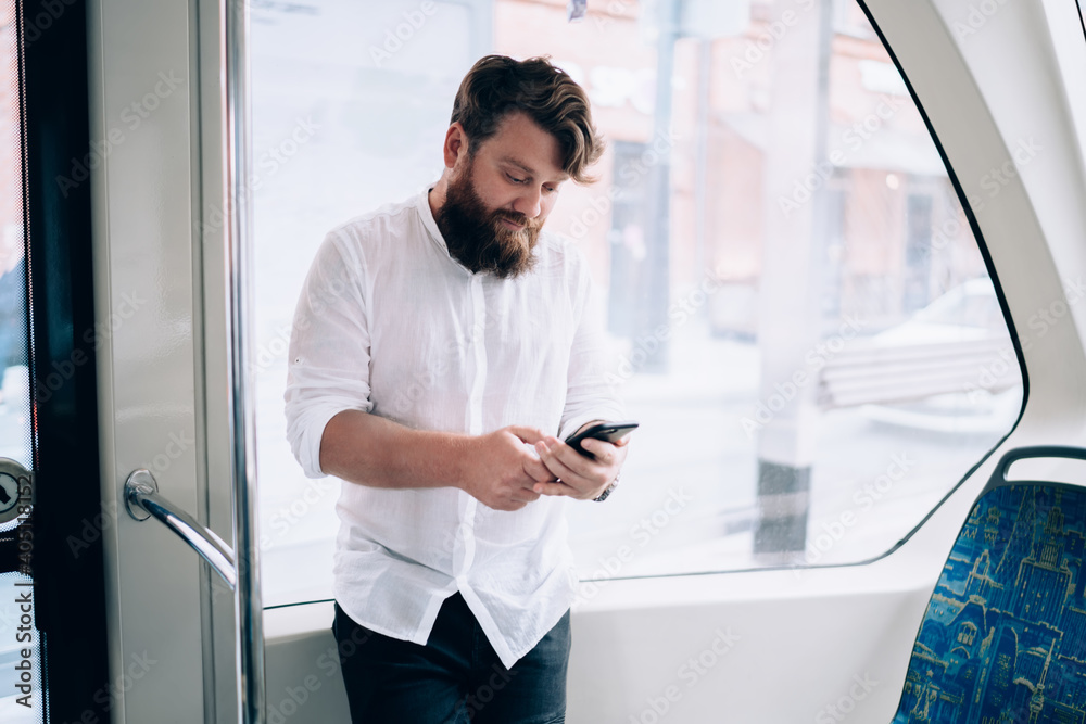Focused man using smartphone in train Focused man using smartphone in train