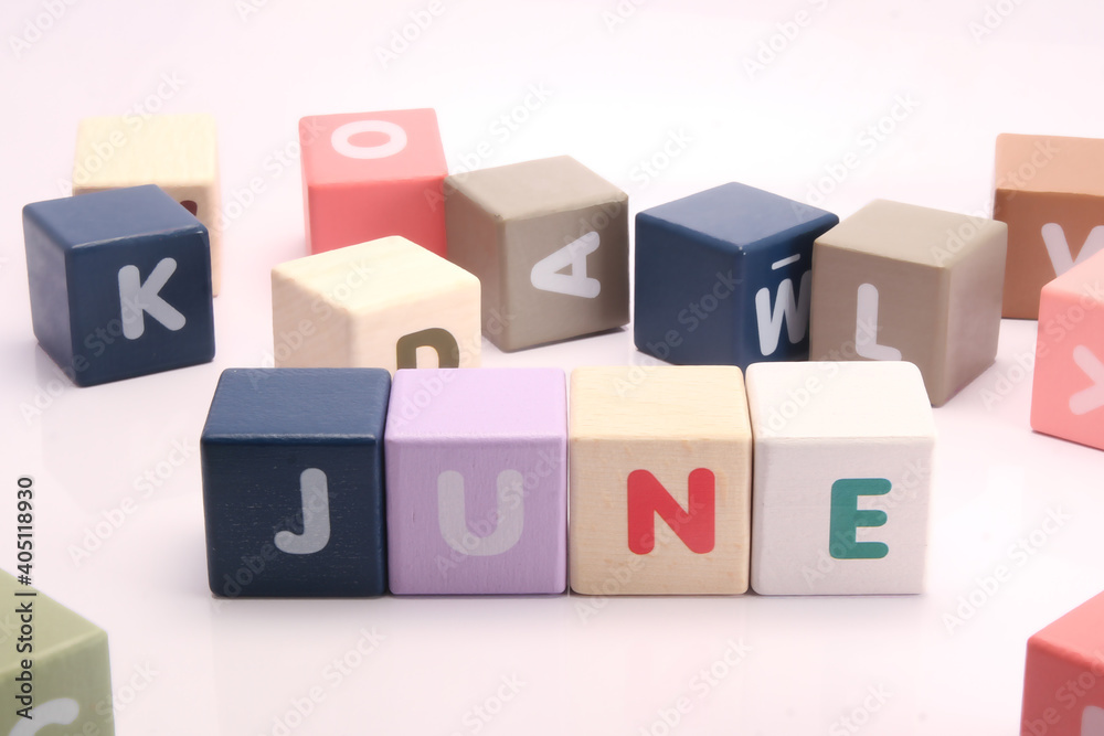 Cubes each with a letter on it written the word June Cubes each with a letter on it written the word June