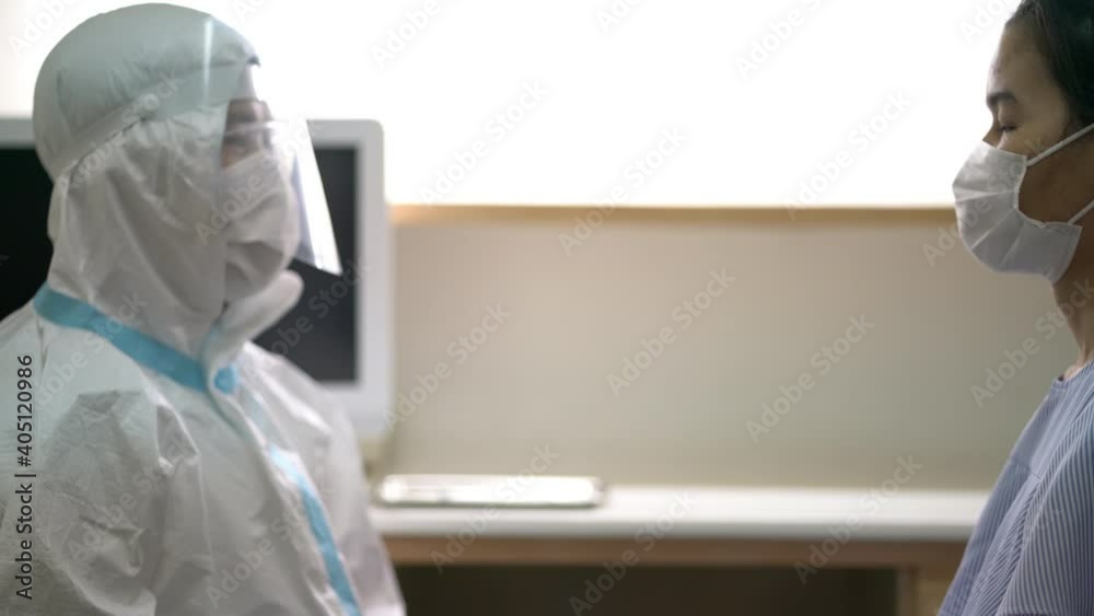 video of Asian doctor or nurse wearing ppe suit and face mask in hospital with an injection vaccine for covid-19 or corona virus patient. Corona virus, Covid-19, virus outbreak or medical mask concept video of Asian doctor or nurse wearing ppe suit and face mask in hospital with an injection vaccine for covid-19 or corona virus patient. Corona virus, Covid-19, virus outbreak or medical mask concept