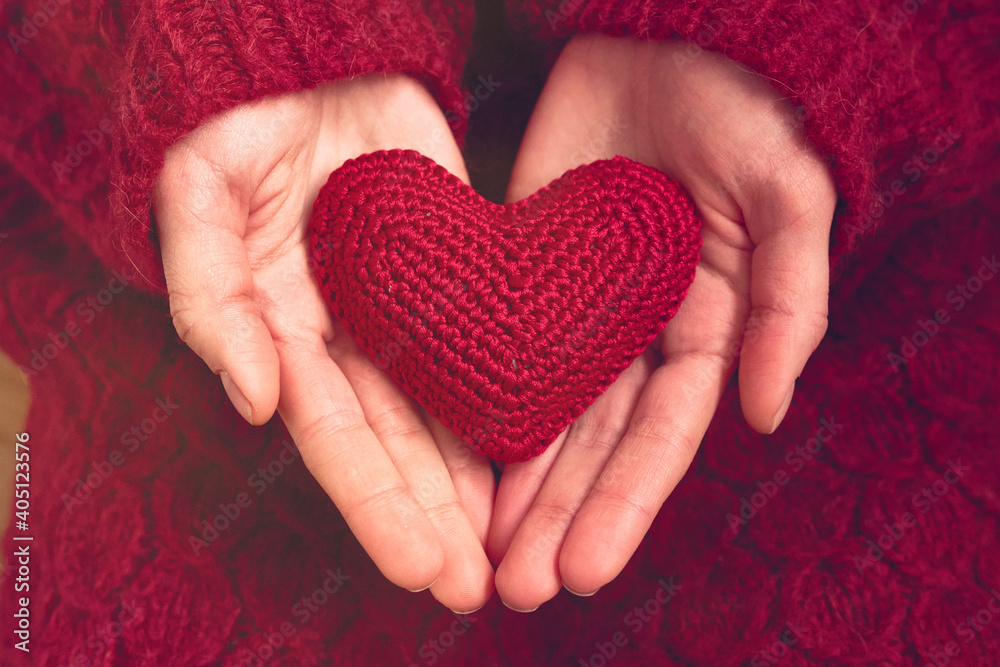 Woman hands holding red heart Woman hands holding red heart