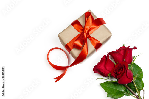 Holidays and Valentin’s day romantic flat lay. Gift box with red ribbon and red rose on white background.