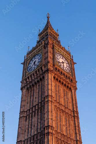 Canvas Print symmetrical london big ben tower with plain blue sky background