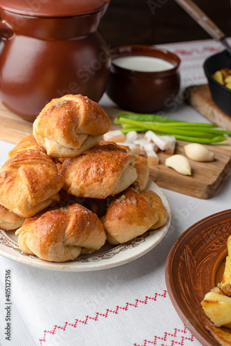 Ukrainian or Russian traditional feast. Garlic buns. Fried potatoes with bacon. Copy space © Valeriya