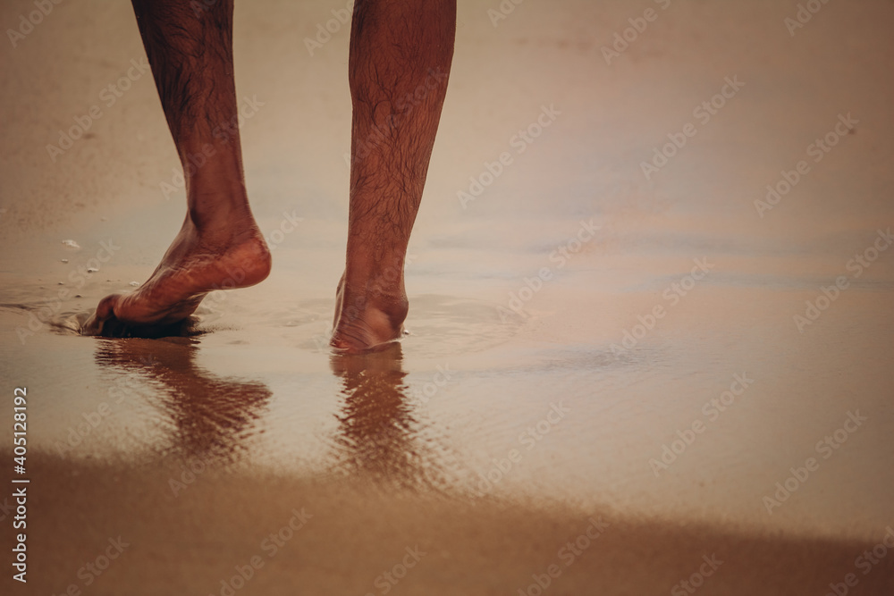 Person enjoying the waves in the beach with bare foot, Marina Beach, Chennai. Focus set on the foot. Person enjoying the waves in the beach with bare foot, Marina Beach, Chennai. Focus set on the foot.