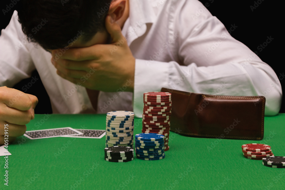 Unfortunate young man feeling sad, desperate and stressed after losing his  money playing poker and blackjack in a nightly casino. copy space Photos |  Adobe Stock