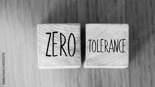 Zero tolerance - words from wooden blocks with letters, severely punishing all unacceptable behaviour, zero tolerance concept, woooden background photo