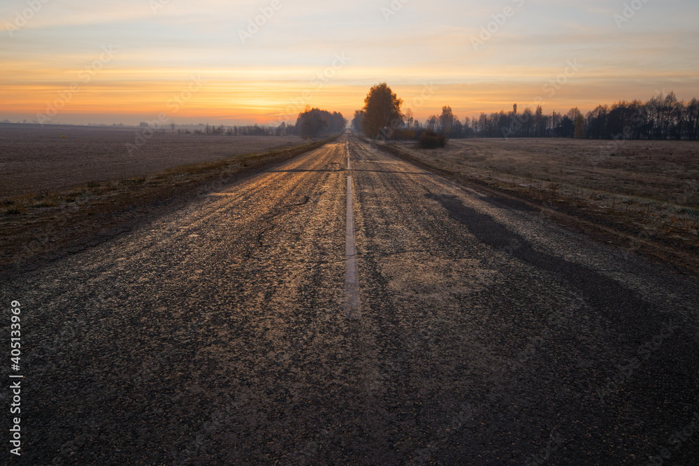wide the road beyond the horizon at dawn