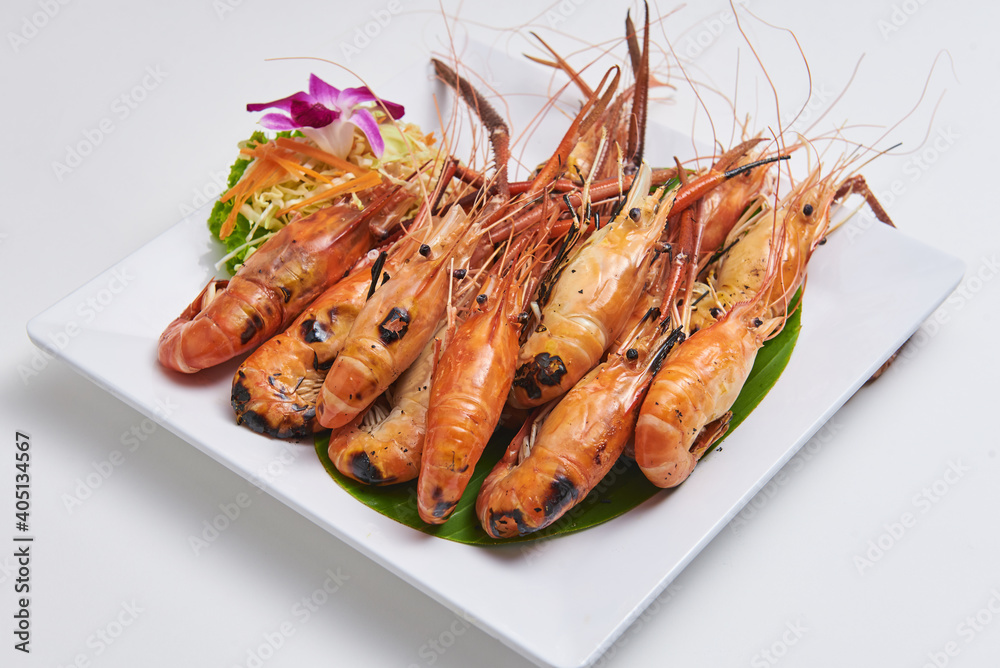 Grilled shrimp served on a white plate Popular seafood dishes Grilled shrimp served on a white plate Popular seafood dishes