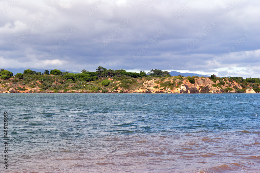 Sea View with Distant Tree Covered Hills and Cloudy Sky Sea View with Distant Tree Covered Hills and Cloudy Sky