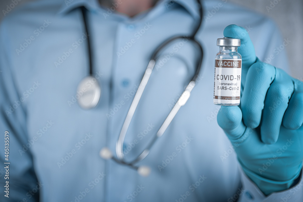 Doctor with a stethoscope on shoulder holding in hand COVID-19 , coronavirus, SARS-cov-2 vaccine. Healthcare And Medical concept.Development and creation vaccine Doctor with a stethoscope on shoulder holding in hand COVID-19 , coronavirus, SARS-cov-2 vaccine. Healthcare And Medical concept.Development and creation vaccine