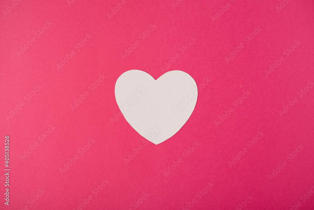 Paper heart over the hot pink pastel background. Abstract background with paper cut shape. Saint Valentine, mother's day, birthday greeting cards, invitation, celebration concept. Paper heart over the hot pink pastel background. Abstract background with paper cut shape. Saint Valentine, mother's day, birthday greeting cards, invitation, celebration concept.