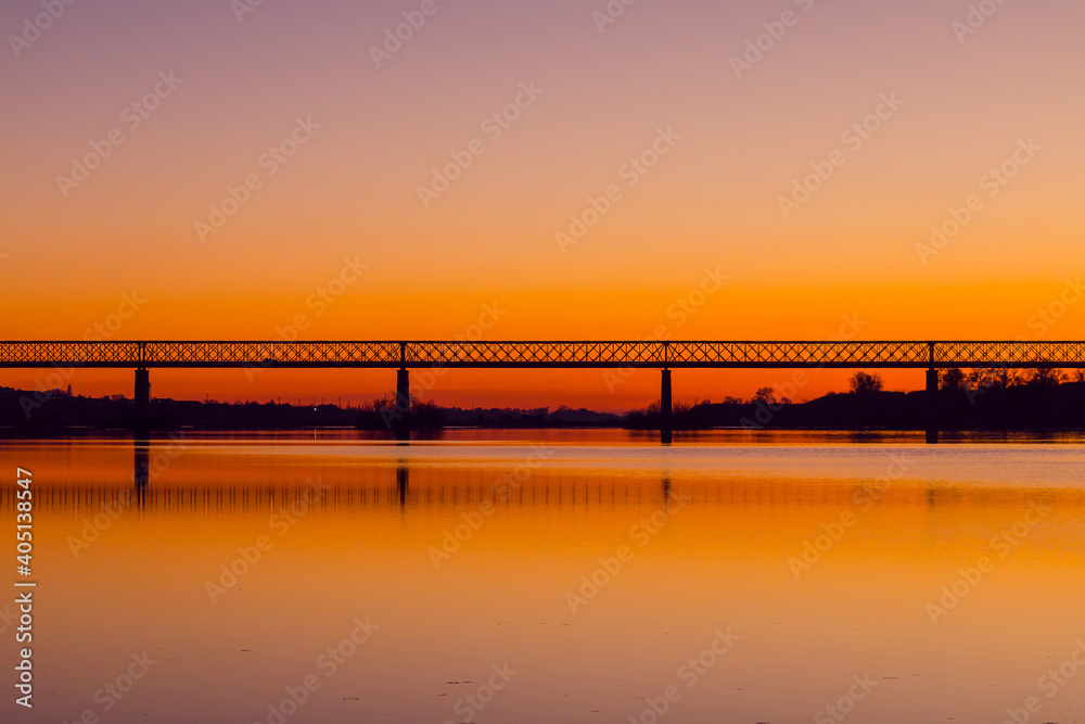 Fototapeta premium Bridge at sunset. Steel bridge over the Tagus river in Chamusca, Portugal