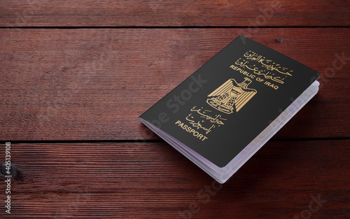 Close up of Iraq passport on a wooden table