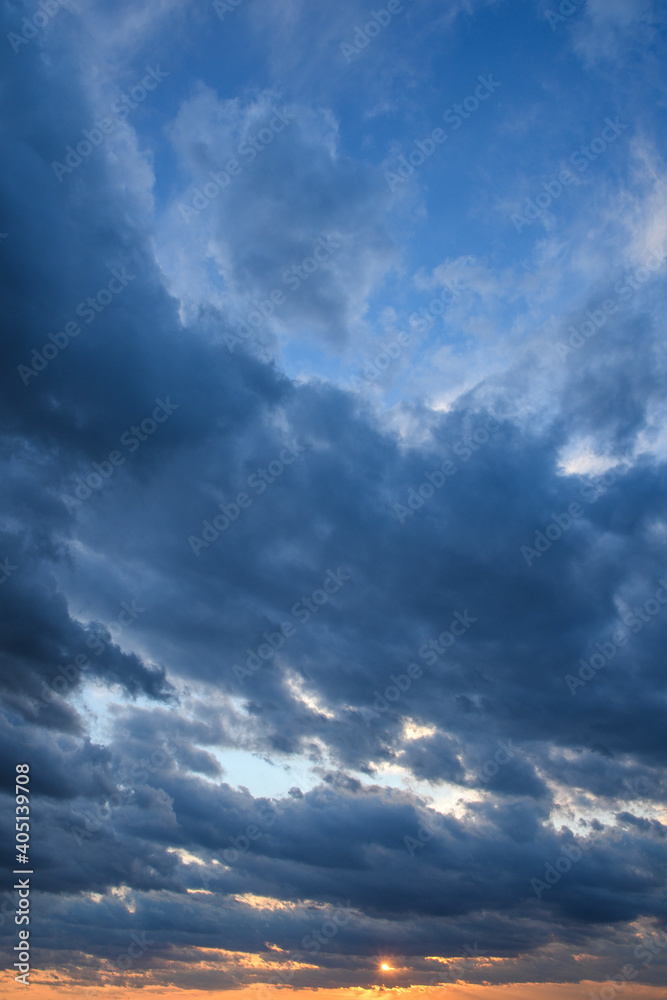 Stormy sky with storm clouns on the sunset with beautiful sun