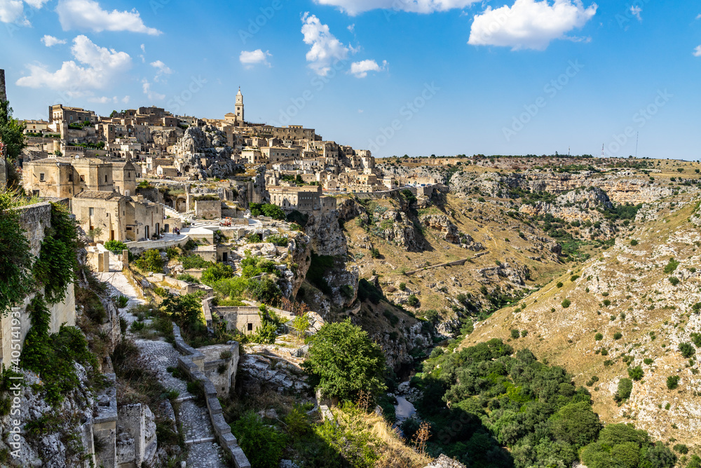 Wide panoramic view of Matera and Gravina canyon seen from rione Casalnuovo, Basilicata, Italy