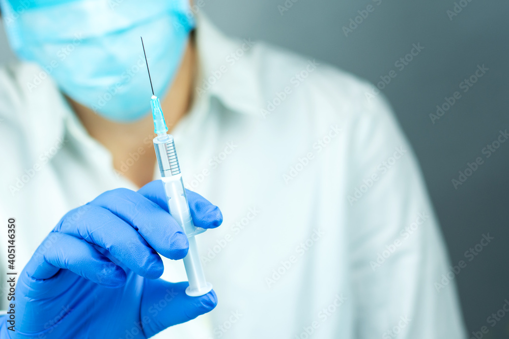 Doctor with a syringe for vaccination. COVID 19. Close-up. Virus protection. Doctor with a syringe for vaccination. COVID 19. Close-up. Virus protection.